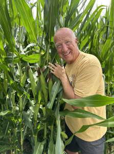 Author Fred Nichols posing happily with his corn plants.