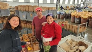 Empleados de la planta de producción de rosas sonriendo.